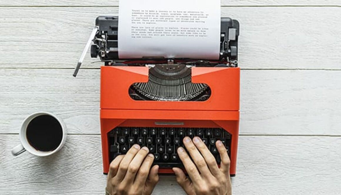 Aerial view of a man typing on a retro typewriter