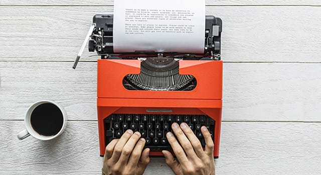 Aerial view of a man typing on a retro typewriter